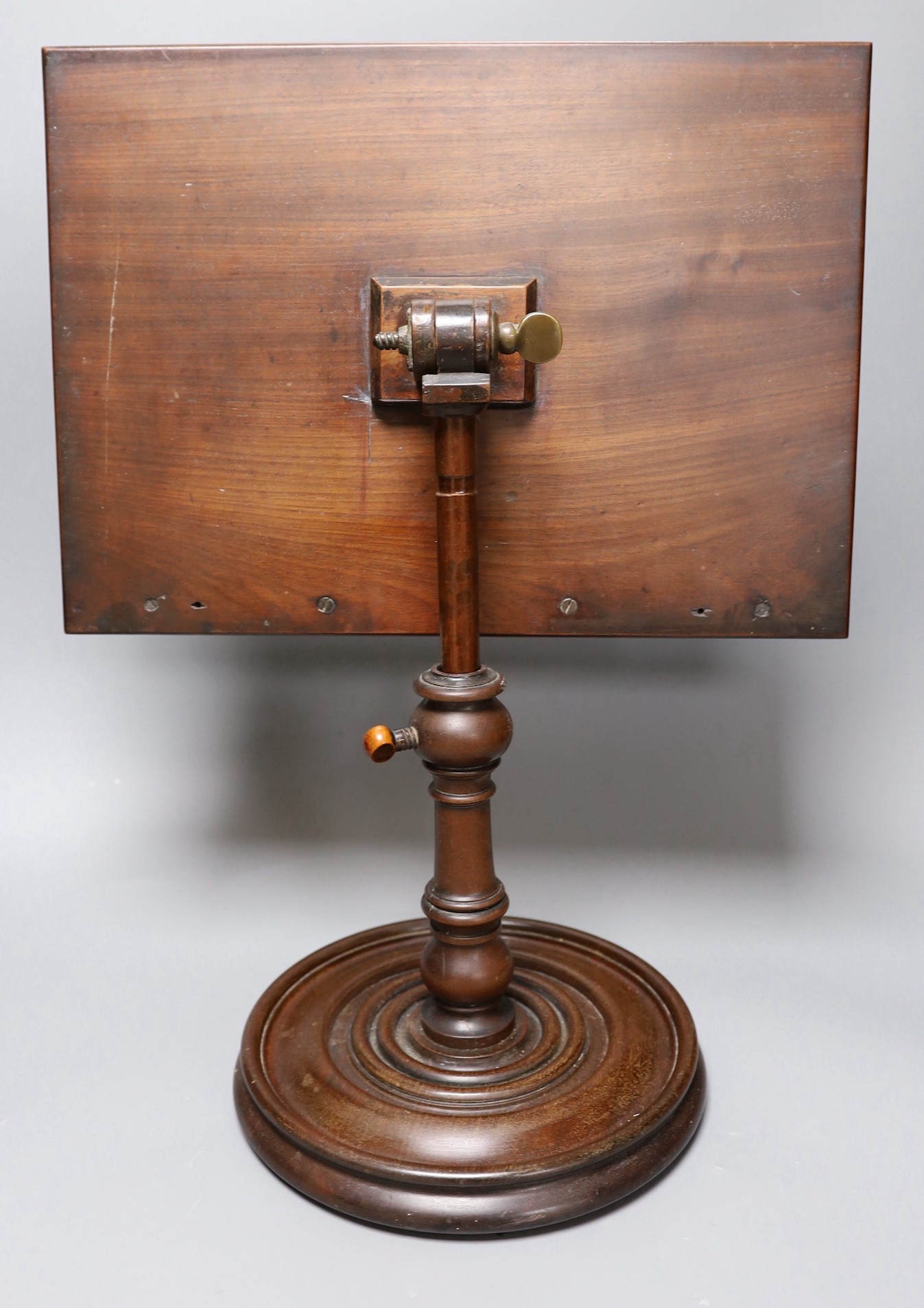 A 19th century turned mahogany book/ music stand, 49 cms high